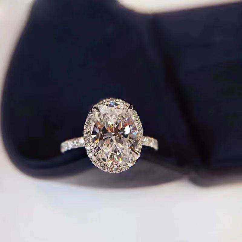 3 CTW colorless oval brilliant cut moissanite halo engagement ring with sterling silver pavé band