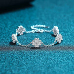 Adjustable 925 sterling silver bracelet with five colorless melee moissanite lucky clover freesia flower charms totaling 0.64 CTW DEW on a rolo chain