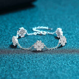 Adjustable 925 sterling silver bracelet with five colorless melee moissanite lucky clover freesia flower charms totaling 0.64 CTW DEW on a rolo chain