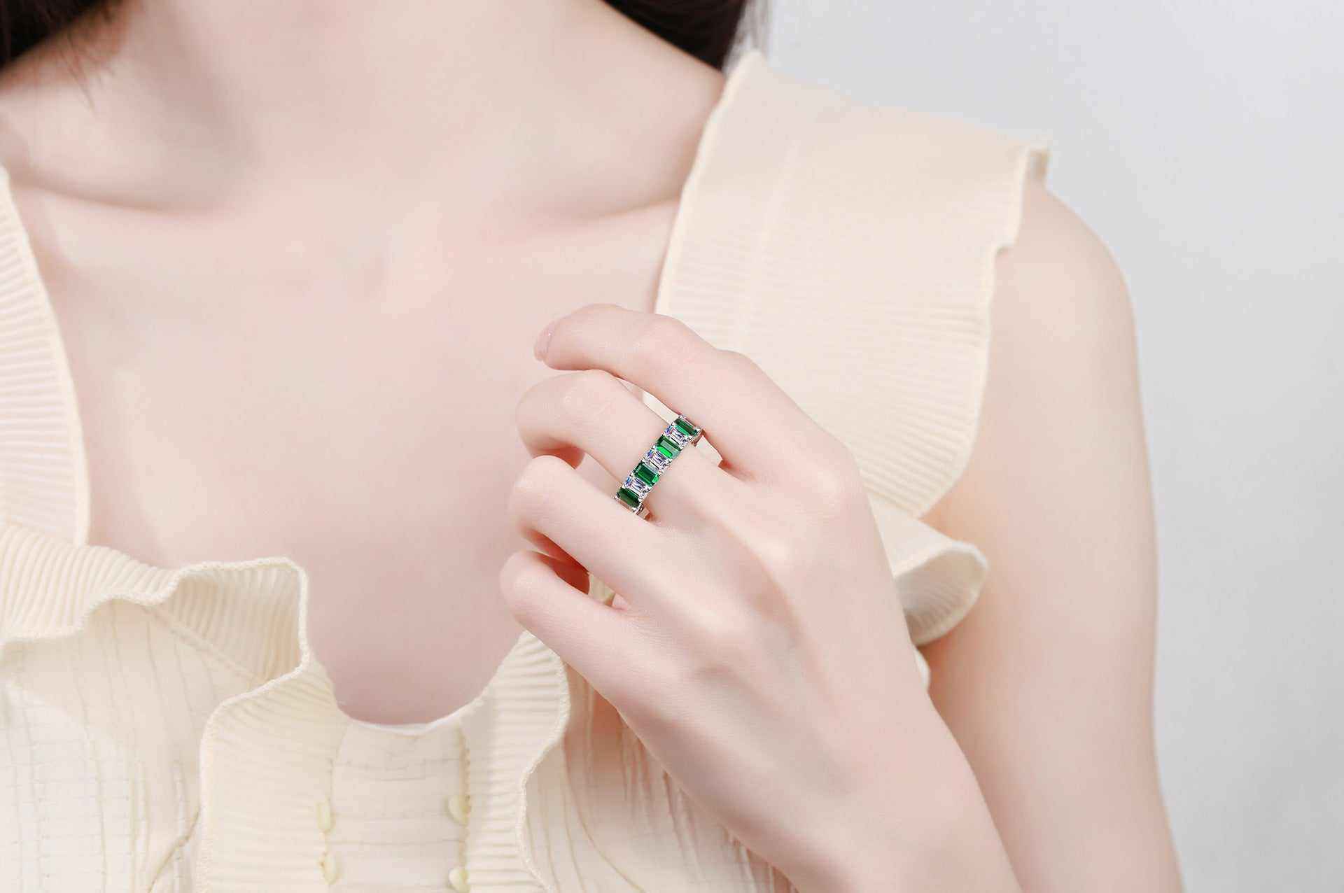White baguette cut cubic zirconia full eternity emerald band ring in platinum plated S925 sterling silver worn on finger