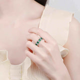 White baguette cut cubic zirconia full eternity emerald band ring in platinum plated S925 sterling silver worn on finger
