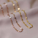 18K yellow gold keyhole lips link chain necklace on soft fabric background