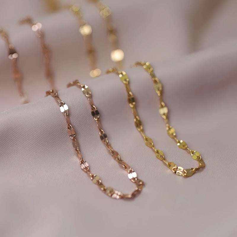 18K yellow gold keyhole lips link chain necklace on soft fabric background