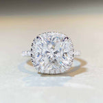 5 CTW colorless cushion cut moissanite engagement ring with sterling silver pavé halo setting