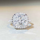 5 CTW colorless cushion cut moissanite engagement ring with sterling silver pavé halo setting