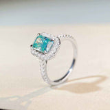 1.8 CTW DEW radiant cut Paraíba mint green moissanite halo engagement ring in sterling silver with pavé cubic zirconia band