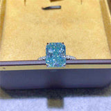 1.8 CTW DEW radiant cut blue green moissanite solitaire engagement ring in sterling silver with pavé accents