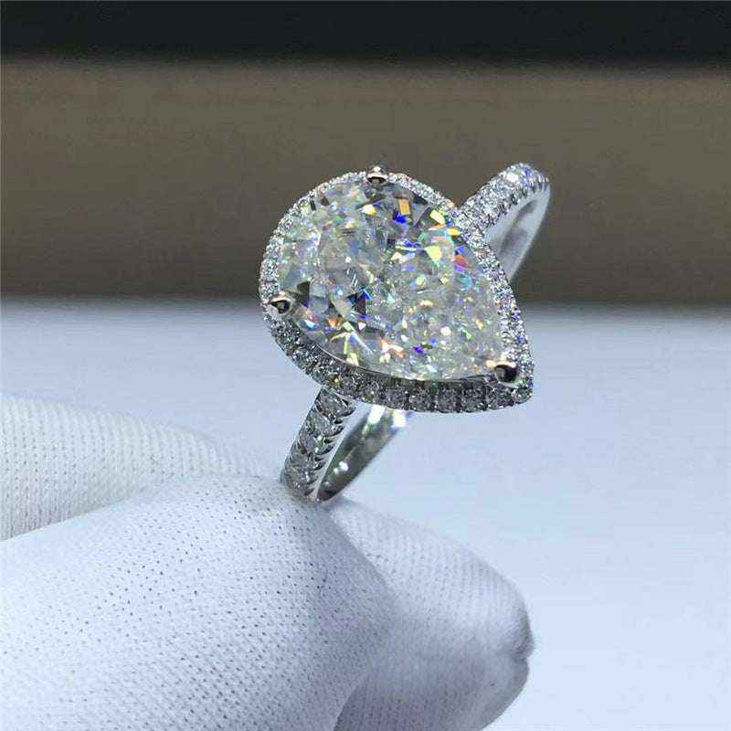 2.1 CTW colorless pear cut moissanite halo engagement ring in sterling silver with pavé accent stones