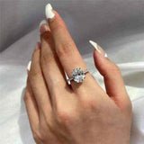 2.1 CTW DEW oval brilliant cut moissanite solitaire engagement ring in sterling silver with pavé side stones