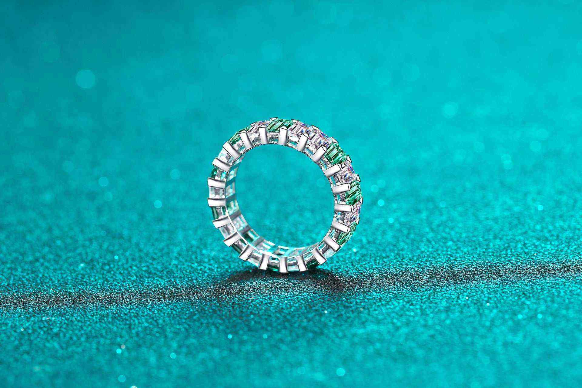 Platinum plated S925 sterling silver eternity band with white and emerald green baguette cut cubic zirconia stones.