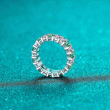 Platinum plated S925 sterling silver eternity band with white and emerald green baguette cut cubic zirconia stones.