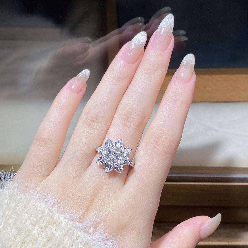 2.4 CTW DEW cushion cut moissanite sunflower halo engagement ring in sterling silver on hand