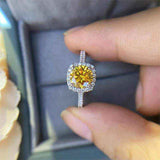 1 CTW DEW round brilliant cut yellow moissanite halo engagement ring in sterling silver with cushion outline and pavé band