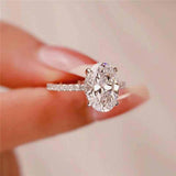 2.1 CTW DEW colorless oval brilliant cut moissanite solitaire engagement ring in sterling silver with pavé accents