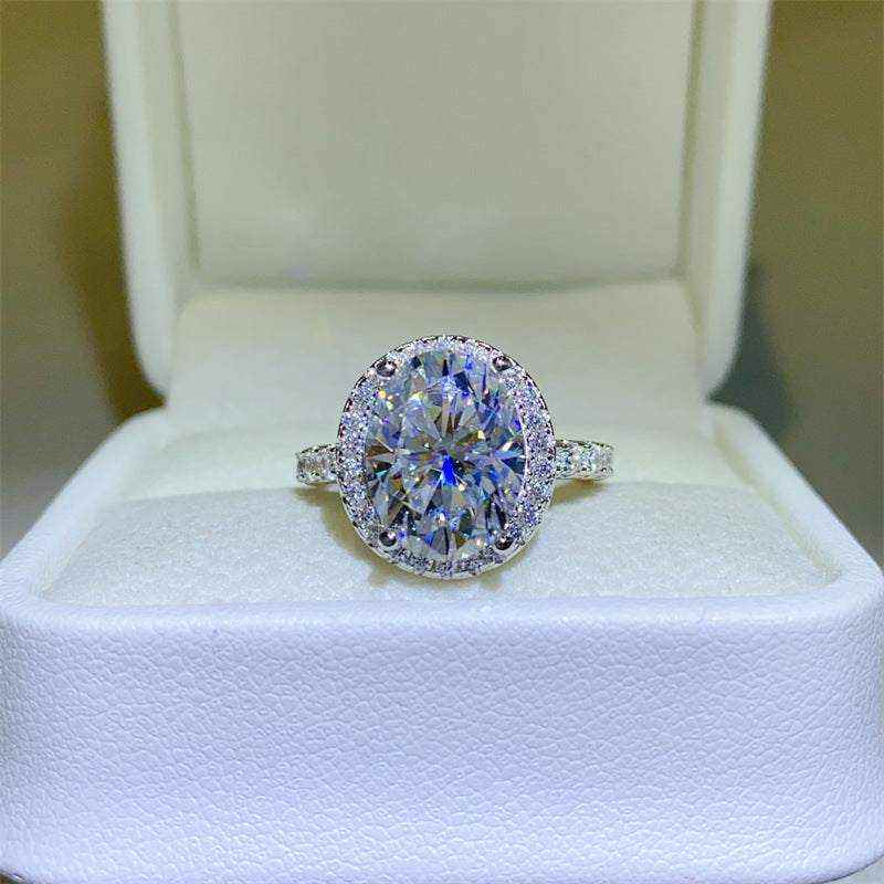 4.2 CTW DEW colorless oval brilliant cut moissanite engagement ring with sterling silver pavé halo setting