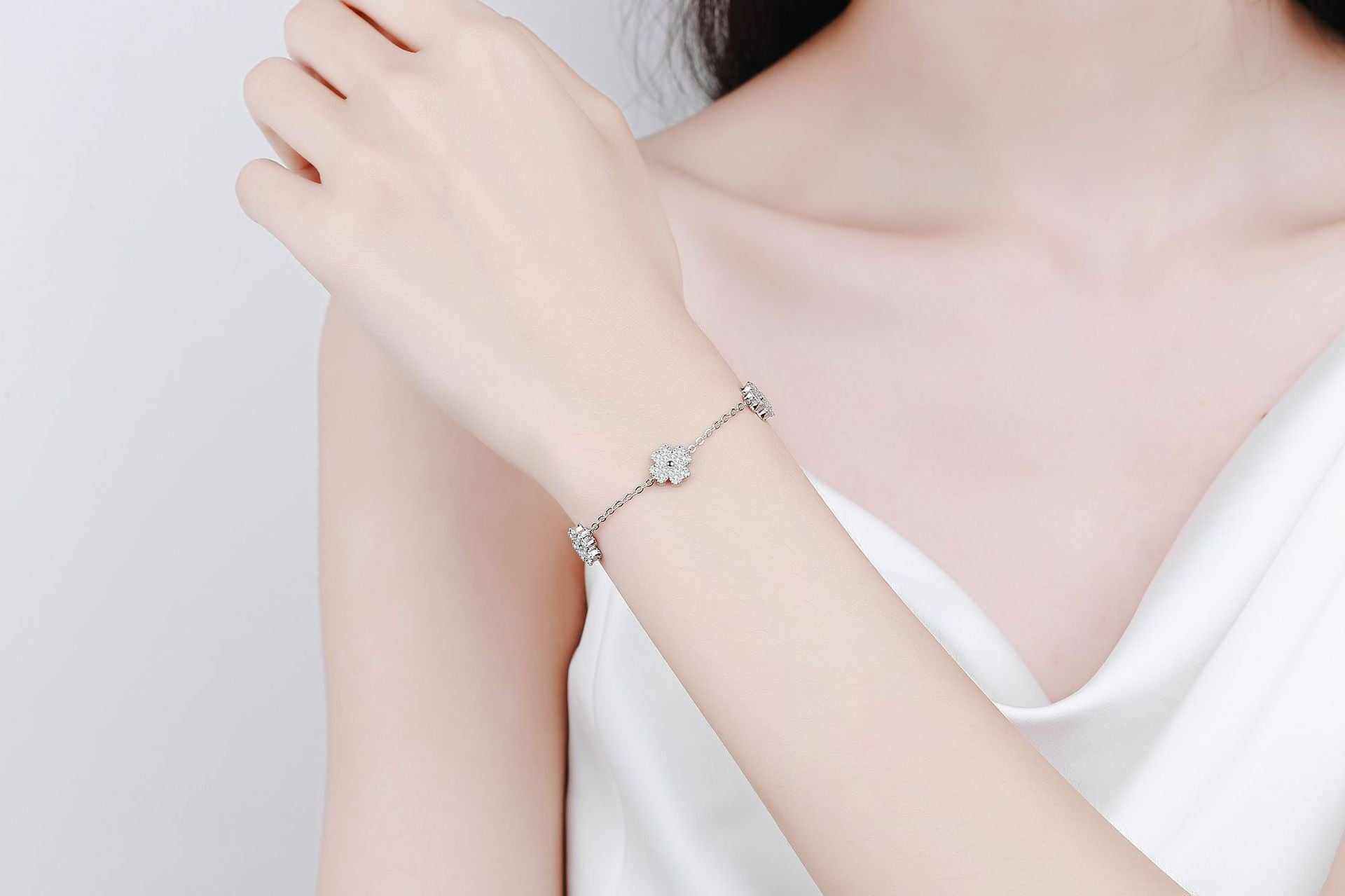 64 CTW DEW lucky clover freesia flower colorless melee moissanites adjustable bracelet on sterling silver rolo chain worn on wrist