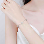 64 CTW DEW lucky clover freesia flower colorless melee moissanites adjustable bracelet on sterling silver rolo chain worn on wrist