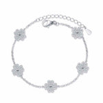 Adjustable 925 sterling silver bracelet with five colorless melee moissanite lucky clover freesia flower charms totaling 0.64 ct. tw. on a rolo chain