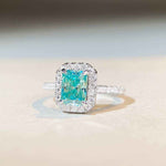 1.8 CTW DEW radiant cut Paraíba mint green moissanite engagement ring with sterling silver pavé halo band