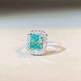 1.8 CTW DEW radiant cut Paraíba mint green moissanite engagement ring with sterling silver pavé halo band