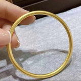 18K yellow gold matte bangle bracelet with minimalist round design, 3mm width, classic and timeless style, worn without clasp