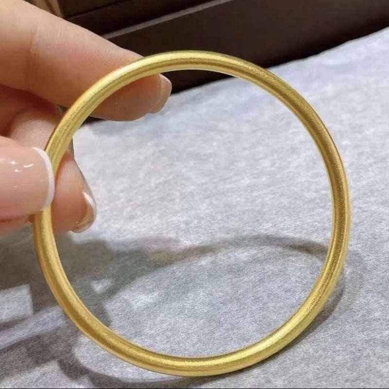 18K yellow gold matte bangle bracelet with minimalist round design, 3mm width, classic and timeless style, worn without clasp