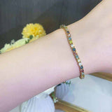 2.3 CTW multicolor round brilliant cut moissanite tennis bracelet in yellow gold plated adjustable 925 sterling silver bolo clasp design on wrist