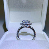 4.2 CTW DEW colorless oval brilliant cut moissanite sterling silver pavé halo engagement ring in white gold setting