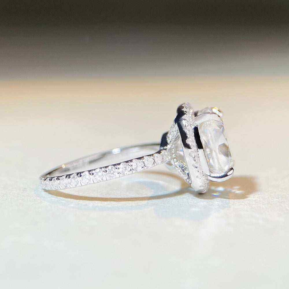 5 CTW colorless cushion cut moissanite engagement ring with crushed ice cut, sterling silver pavé halo setting