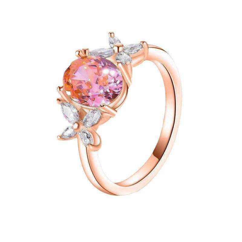 18k rose gold plated sterling silver ring with 2.1 CTW oval cut pink moissanite and four leaf flower cubic zirconia accents