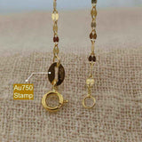 18K yellow gold lips link chain necklace with keyhole clasp and Au750 stamp on beige fabric background