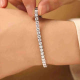 4.6-17.5 CTW colorless round brilliant cut moissanite tennis bracelet in 925 sterling silver chain worn on wrist