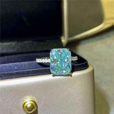 1.8 CTW DEW radiant cut blue green moissanite engagement ring with sterling silver pavé band