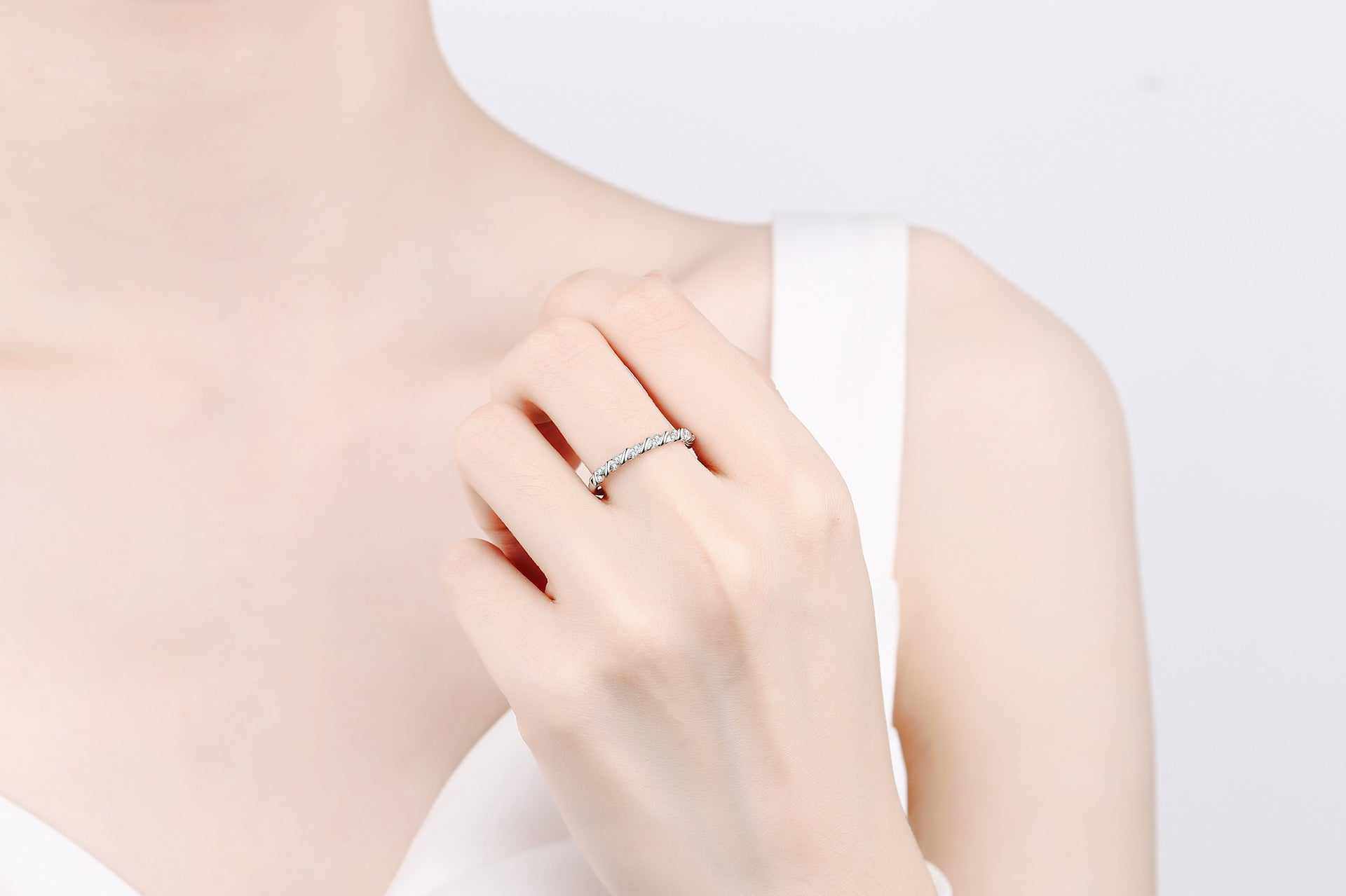 Micro pave croissant shaped moissanite ring in platinum plated S925 sterling silver worn on hand