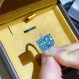 1.8 CTW DEW radiant cut blue green moissanite solitaire engagement ring in sterling silver pavé setting