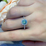 2.7 CTW DEW green moissanite halo engagement ring in sterling silver on hand