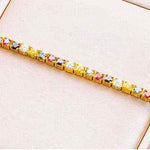 2.3 CTW multi-color round brilliant cut moissanite tennis bracelet in yellow gold plated 925 sterling silver with adjustable bolo clasp