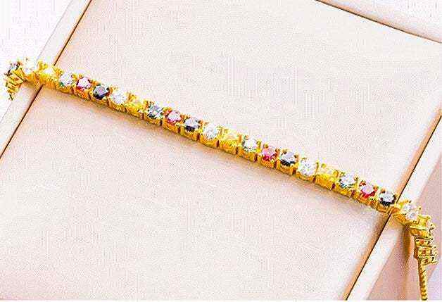 2.3 CTW multi-color round brilliant cut moissanite tennis bracelet in yellow gold plated 925 sterling silver with adjustable bolo clasp