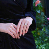 3 CTW DEW colorless oval brilliant cut moissanite sterling silver outline pavé halo engagement ring on hand