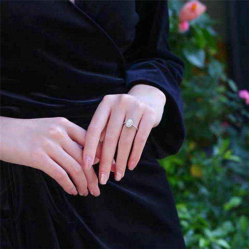 3 CTW DEW colorless oval brilliant cut moissanite sterling silver outline pavé halo engagement ring on hand