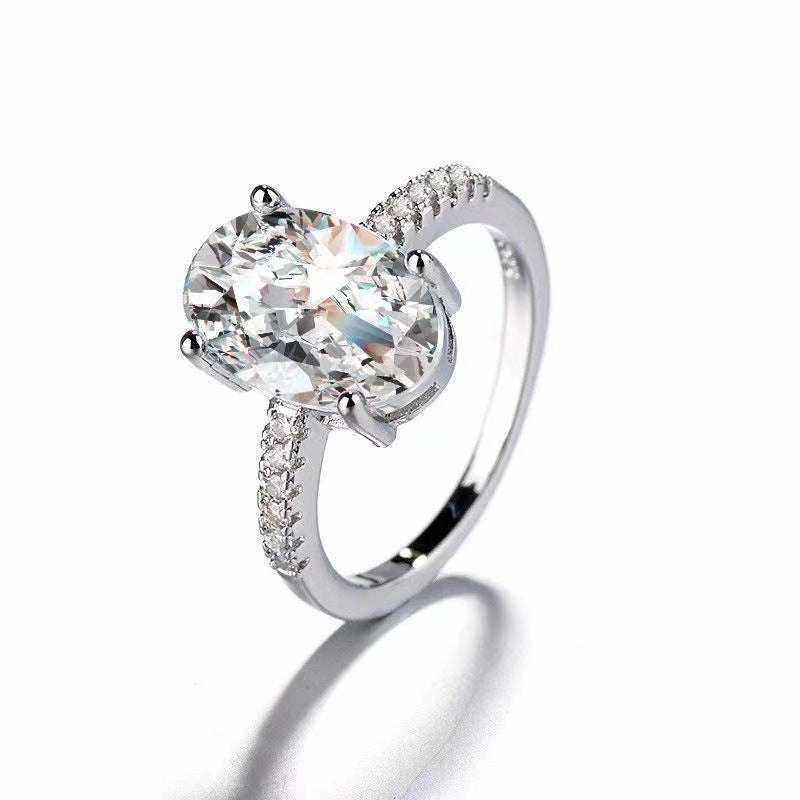 2.1 CTW DEW colorless oval moissanite engagement ring in sterling silver with pavé cubic zirconia accents