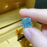 1.8 CTW DEW radiant cut rectangular blue green moissanite solitaire engagement ring in sterling silver pavé setting
