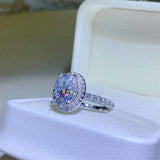 4.2 CTW DEW colorless oval brilliant cut moissanite engagement ring with sterling silver pavé halo setting