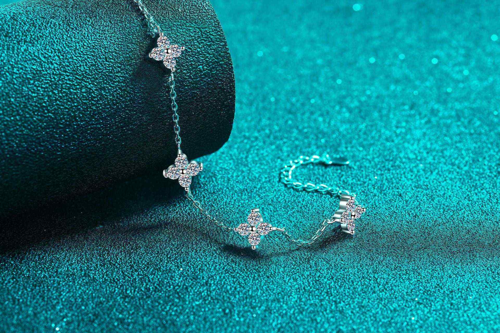 Adjustable sterling silver bracelet with five sparkling four-leaf flower colorless moissanites on rolo chain