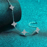 Adjustable sterling silver bracelet with five sparkling four-leaf flower colorless moissanites on rolo chain