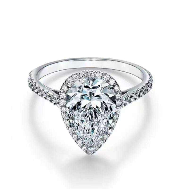2.1 CTW colorless pear cut moissanite halo engagement ring in sterling silver with pavé accents
