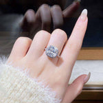 5 CTW DEW colorless cushion cut hybrid brilliant crushed ice moissanite sterling silver pavé halo engagement ring on hand