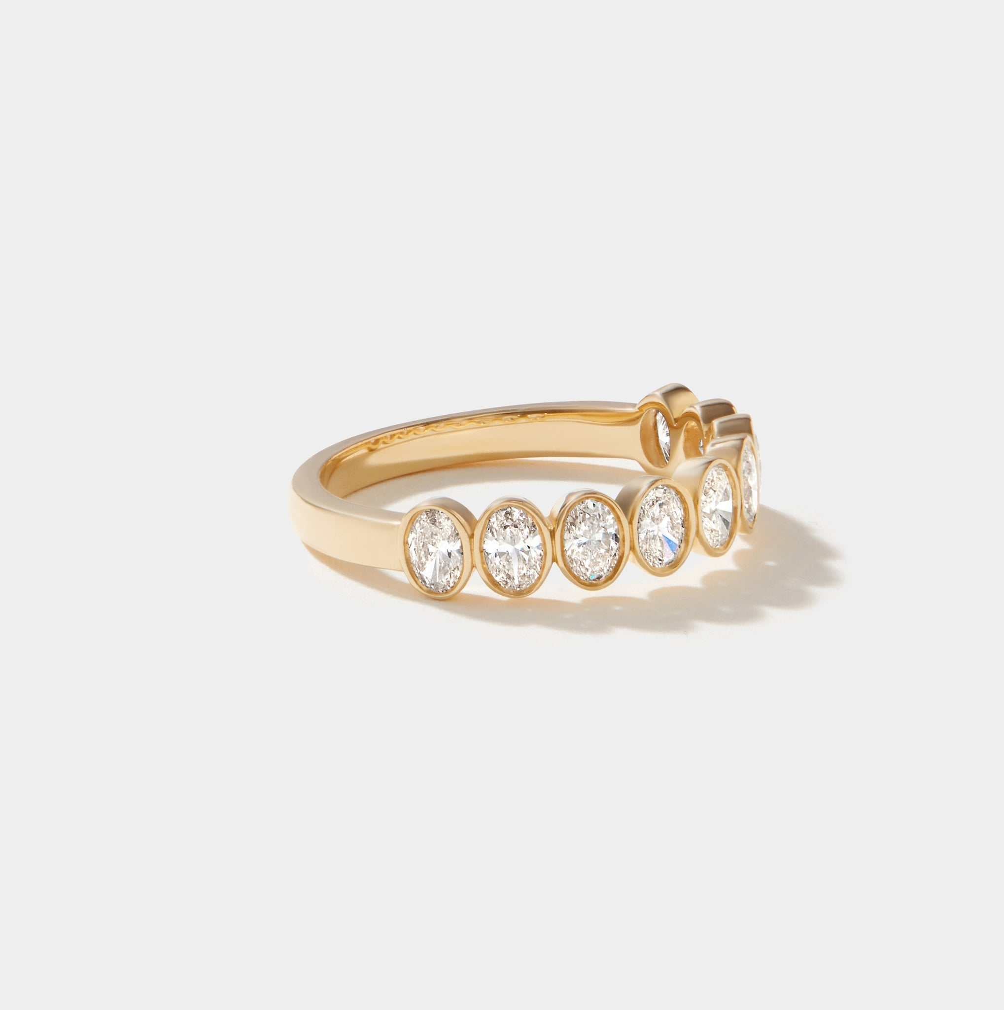 Highland Oval cut diamond bezel set half eternity ring in 14k solid gold