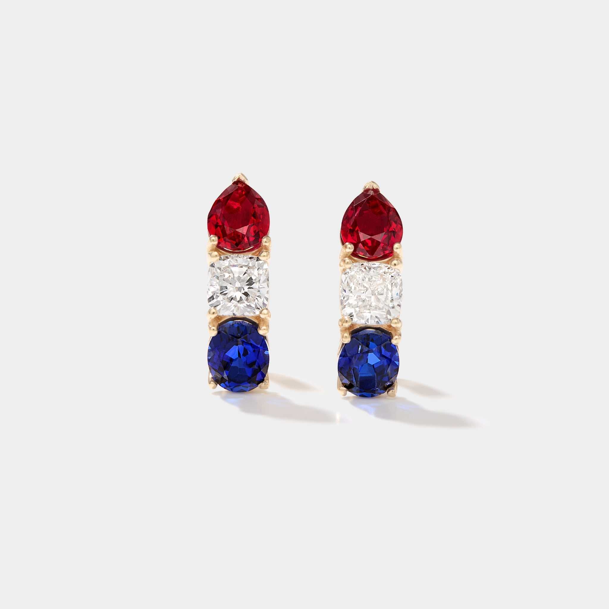 Americana Signature Hoop Earrings with pear-shaped ruby, cushion-cut diamond, oval sapphire in 14k gold, patriotic red white and blue design.