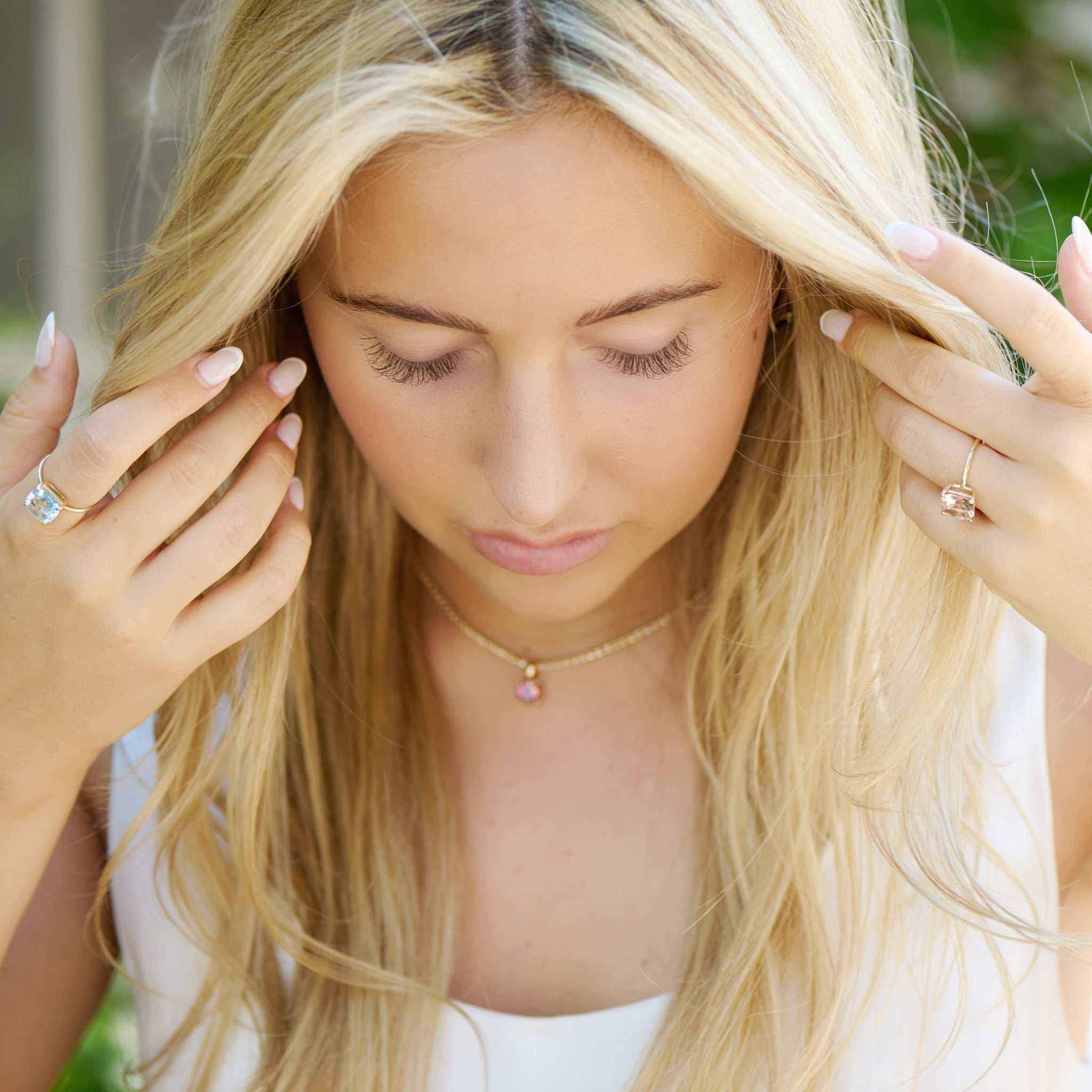 Woman wearing Horizon Nantucket Red Pink Tourmaline 14K Gold Pendant necklace with a delicate pink stone in a custom gold basket setting